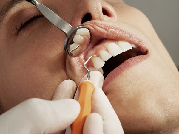 Dental hygienist performing a thorough teeth cleaning in a modern dental chair